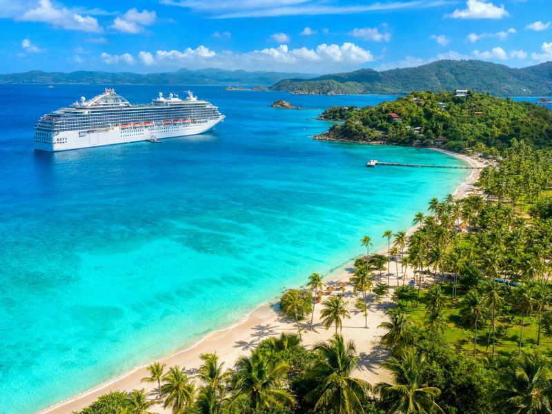 Caribbean luxury cruise — tropical sunset with cruise ship
